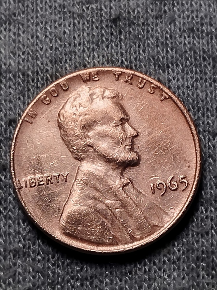 1965 penny BIE die crack error showing raised vertical line between B and E in LIBERTY making it appear to read LIBIERTY
